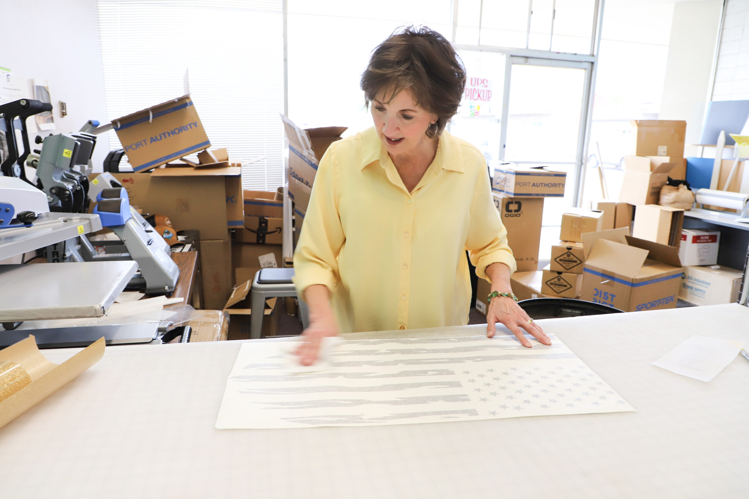 Preparing custom vinyl graphics at Jones Shirts & Signs